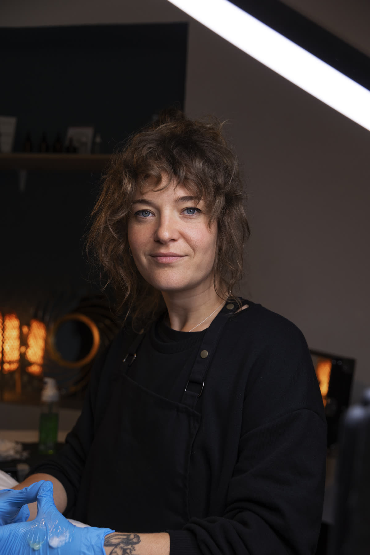 A tattoo artist in her studio